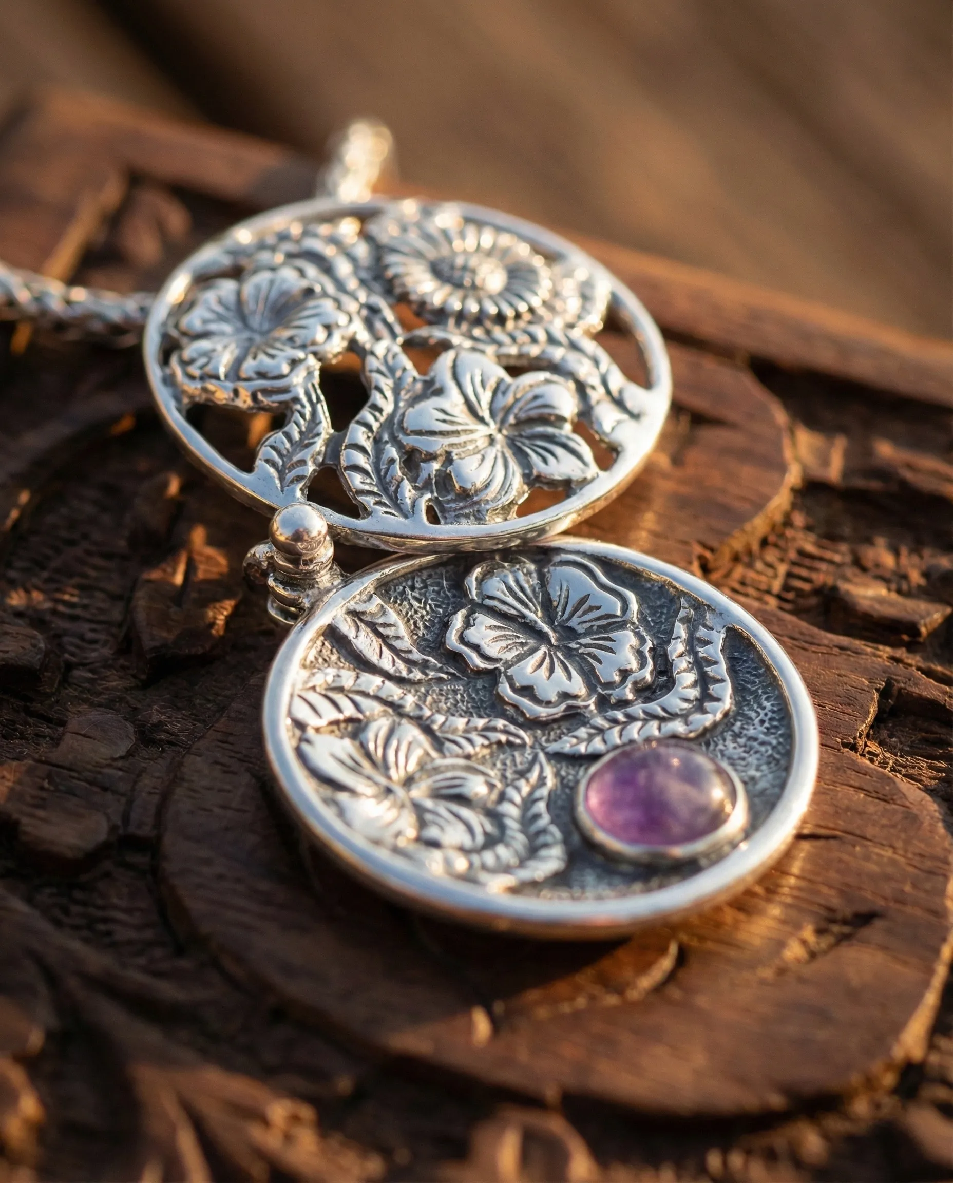 Silver hibiscus locket with purple stone pendant